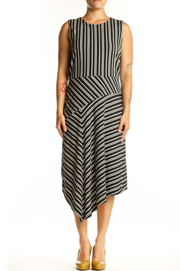 Black and white striped asymmetrical midi dress front view, sleeveless crew neckline design