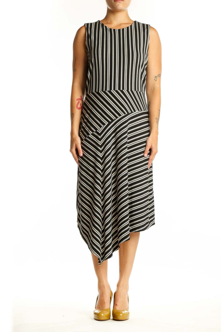 Black and white striped asymmetrical midi dress front view, sleeveless crew neckline design