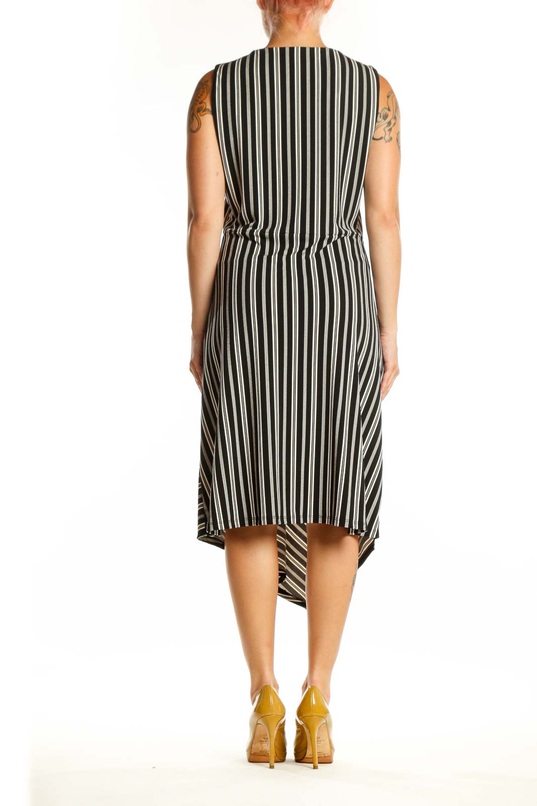 Black and white striped asymmetrical midi dress back view showing asymmetrical hemline