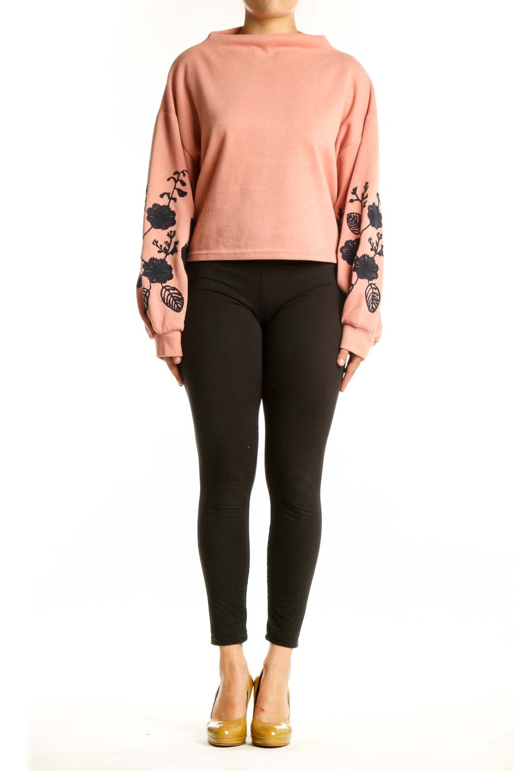 Peach cropped sweatshirt with black floral embroidery on sleeves, front view