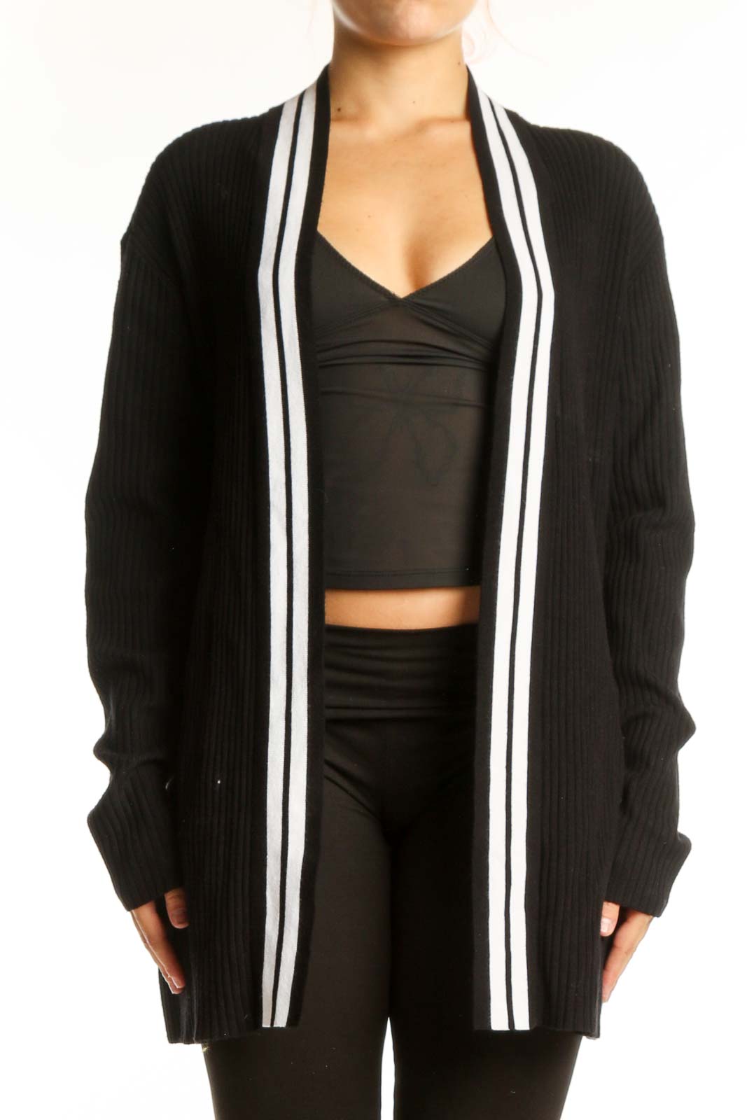 Black ribbed cardigan with white stripe trim worn open over black crop top, front view