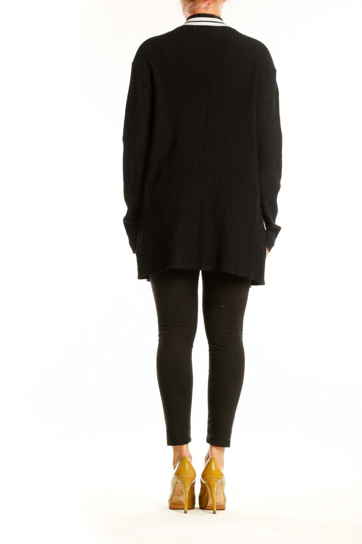 Black ribbed cardigan with white stripe trim showing back view and side profile