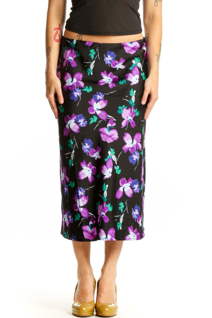 Black floral midi pencil skirt with purple, pink, and teal flower print, front view