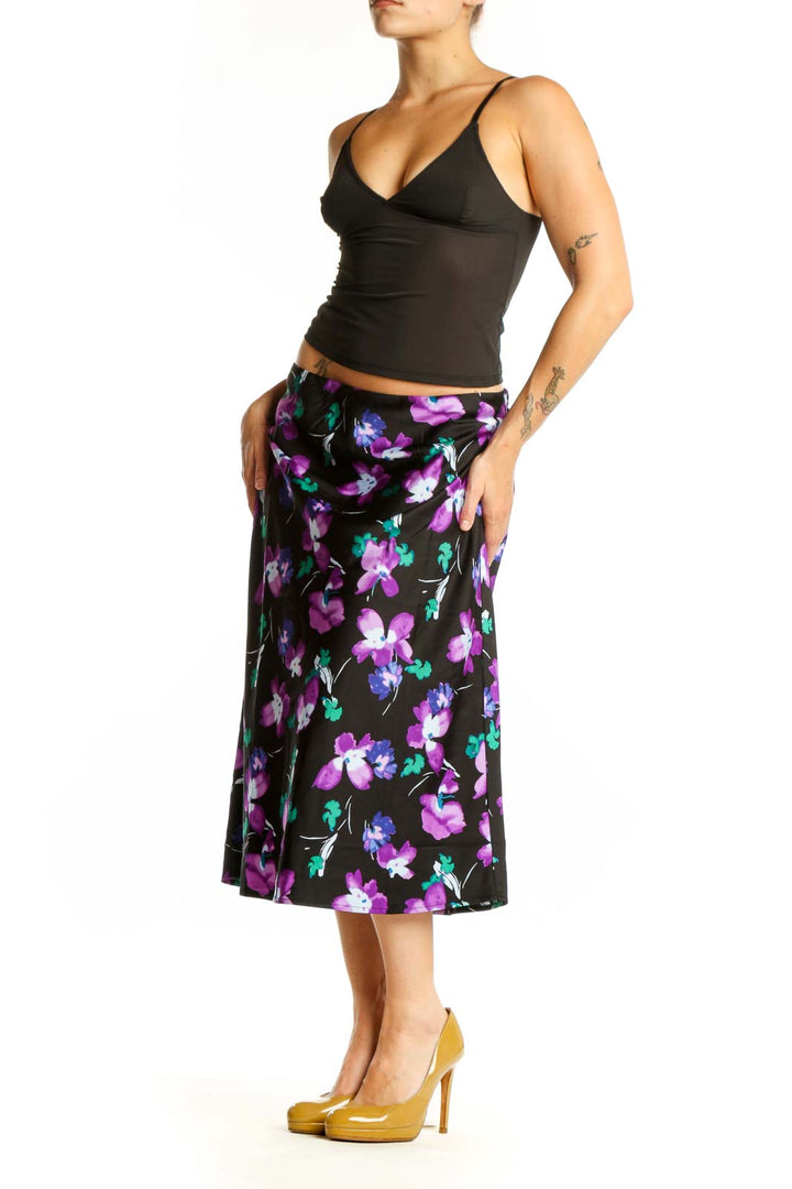Black floral midi pencil skirt with purple, pink, and teal flower print, front view
