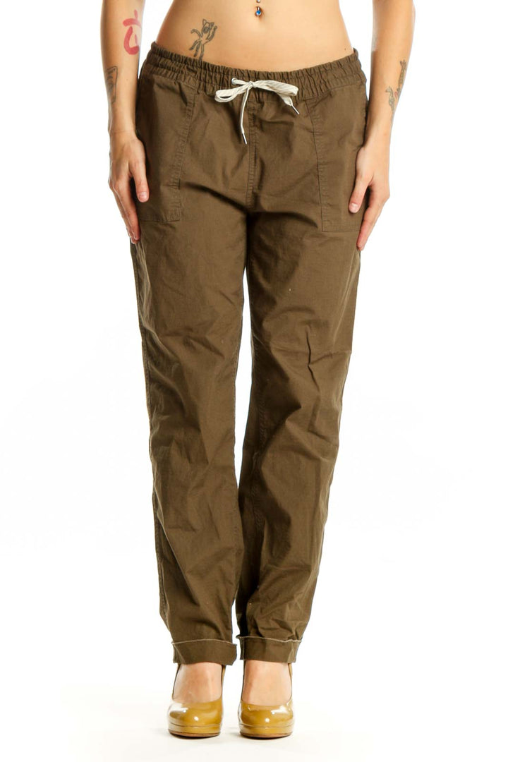 Front view of brown organic cotton cargo pants with drawstring waist and functional pockets