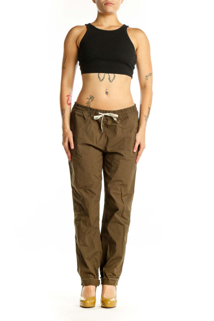 Front view of brown organic cotton cargo pants with drawstring waist and functional pockets