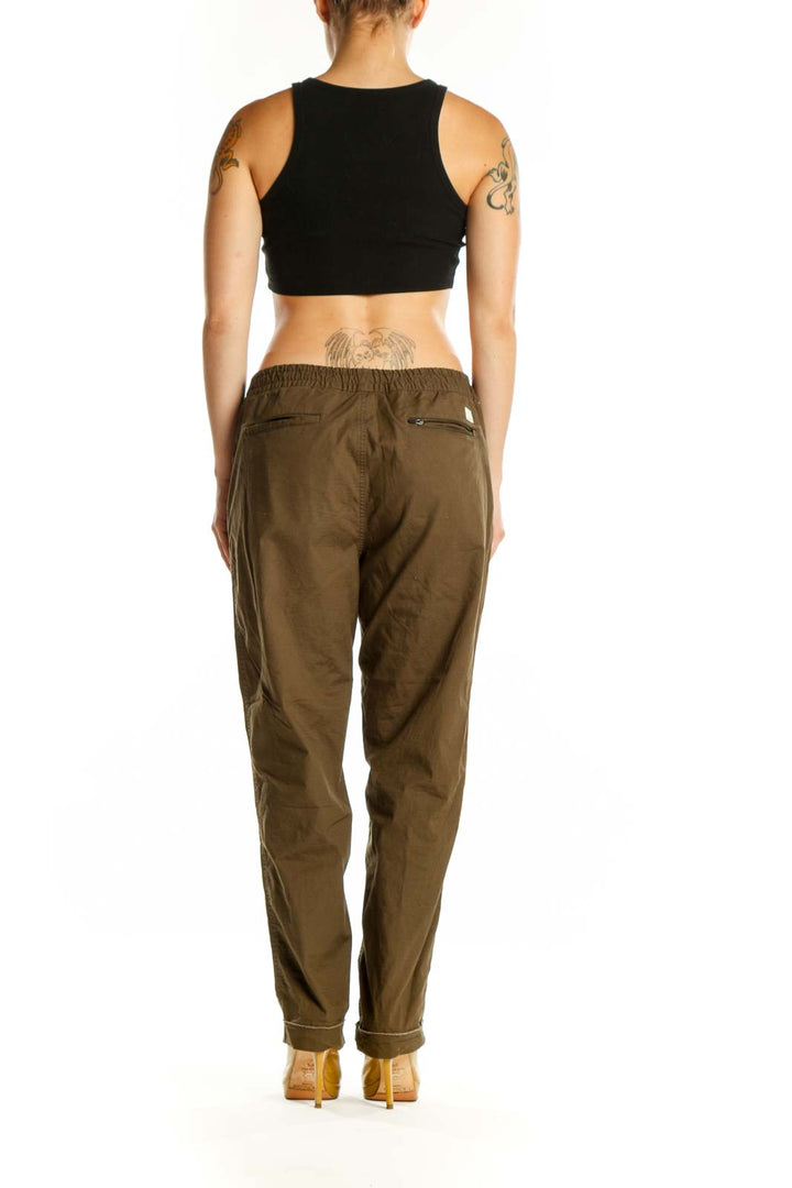 Back view of brown cargo pants showing relaxed fit and rolled cuff detail