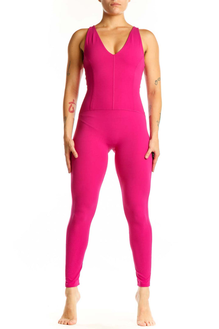 Front view of hot pink sleeveless V-neck jumpsuit by Free People with fitted silhouette and tapered legs