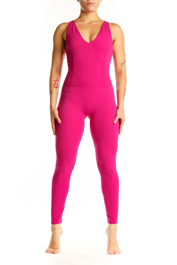 Front view of hot pink sleeveless V-neck jumpsuit by Free People with fitted silhouette and tapered legs