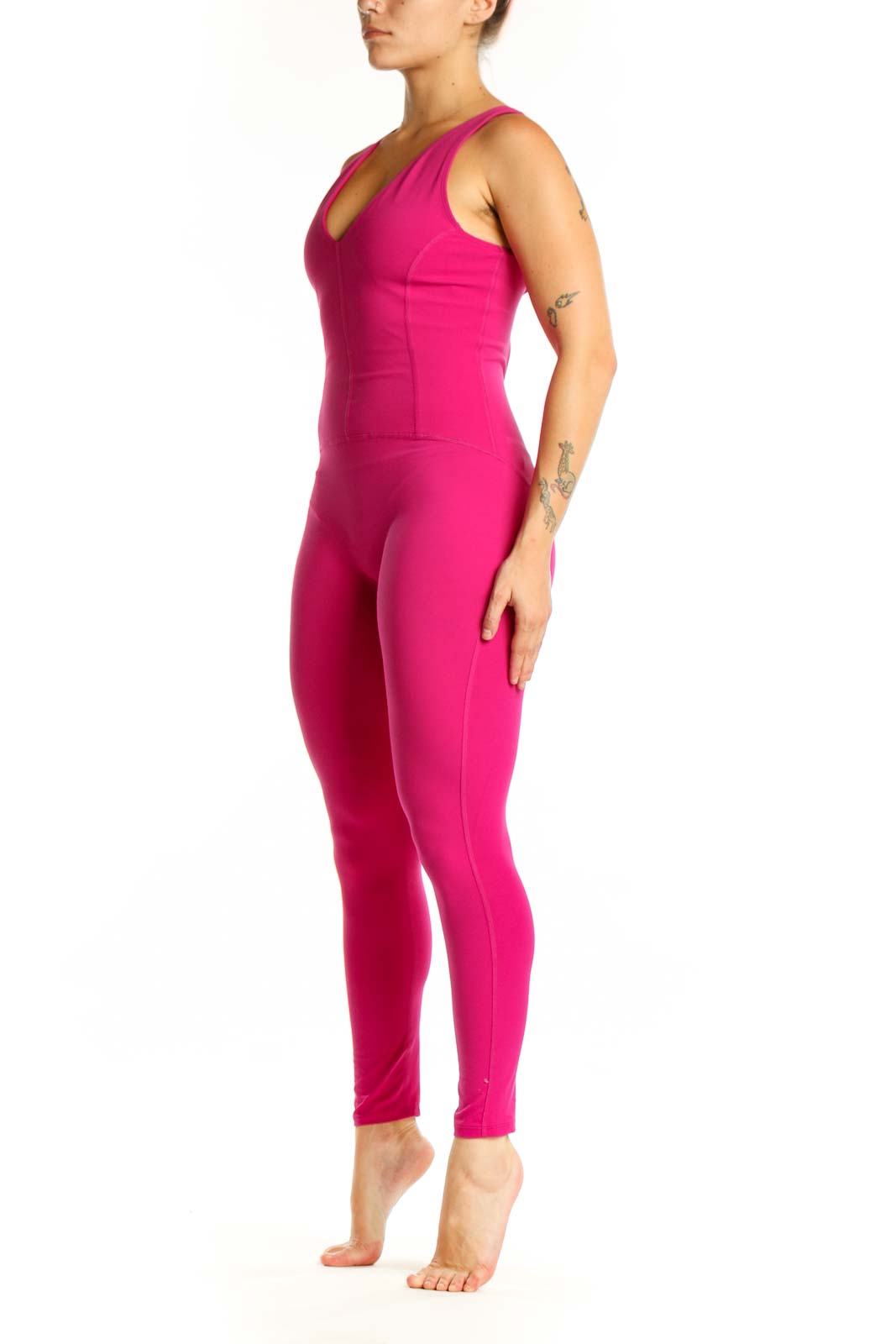 Front view of hot pink sleeveless V-neck jumpsuit by Free People with fitted silhouette and tapered legs