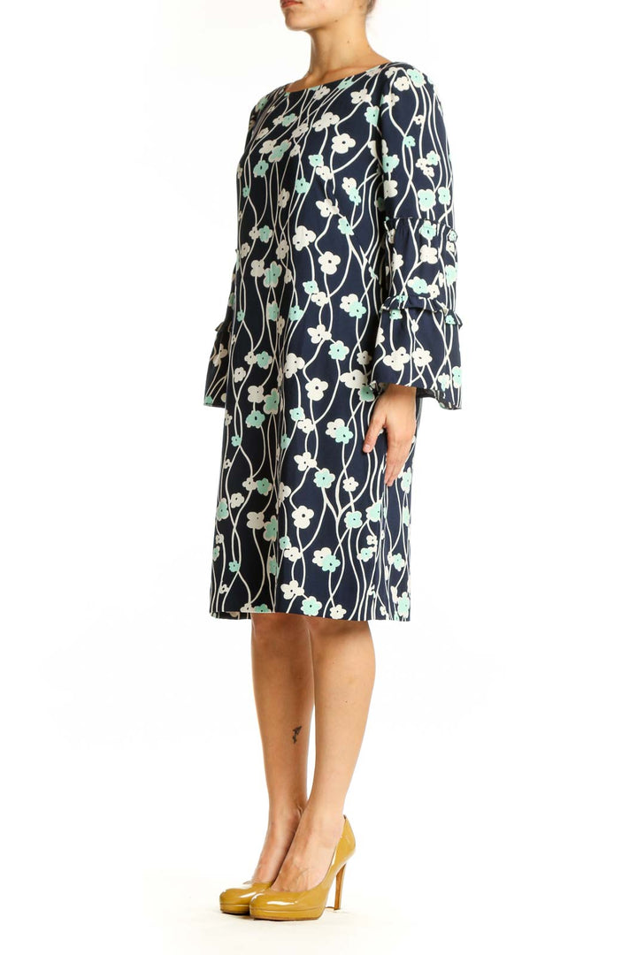 Navy floral canvas dress with bell sleeves and botanical print, front view on model