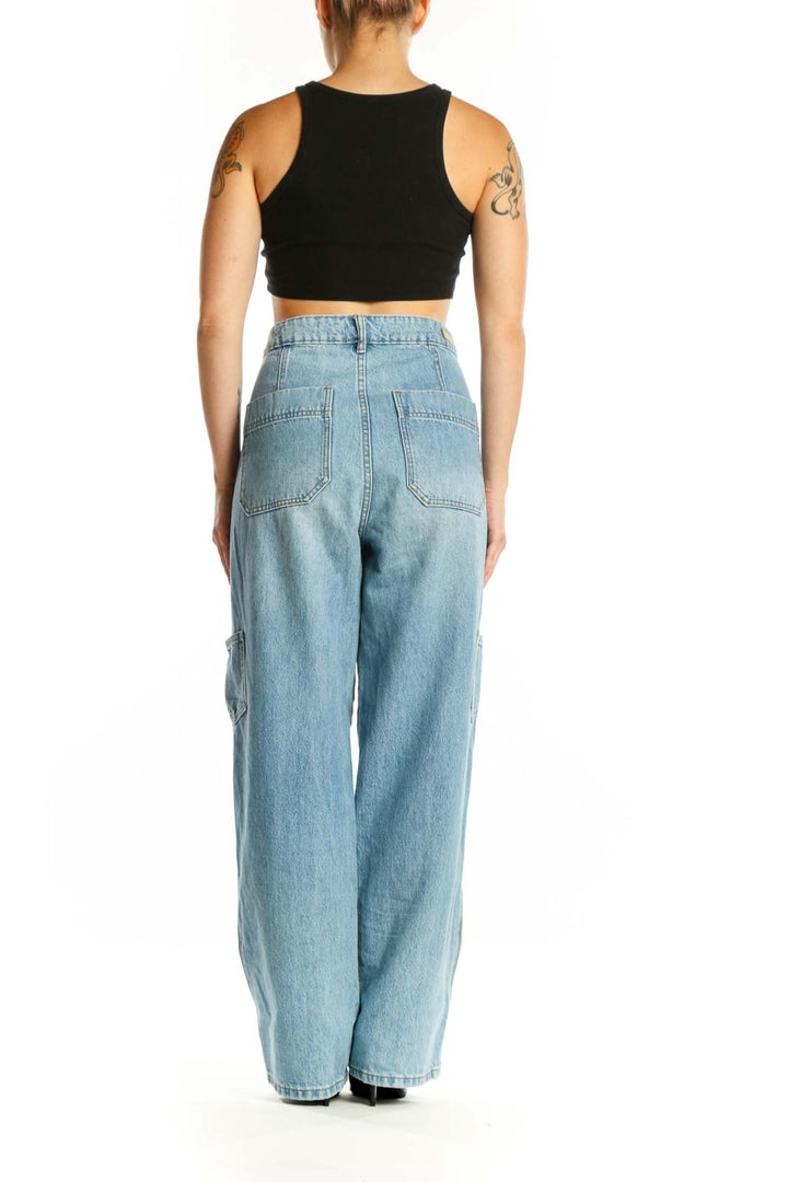 BLANKNYC light wash cargo denim jeans with functional pockets, side view on model