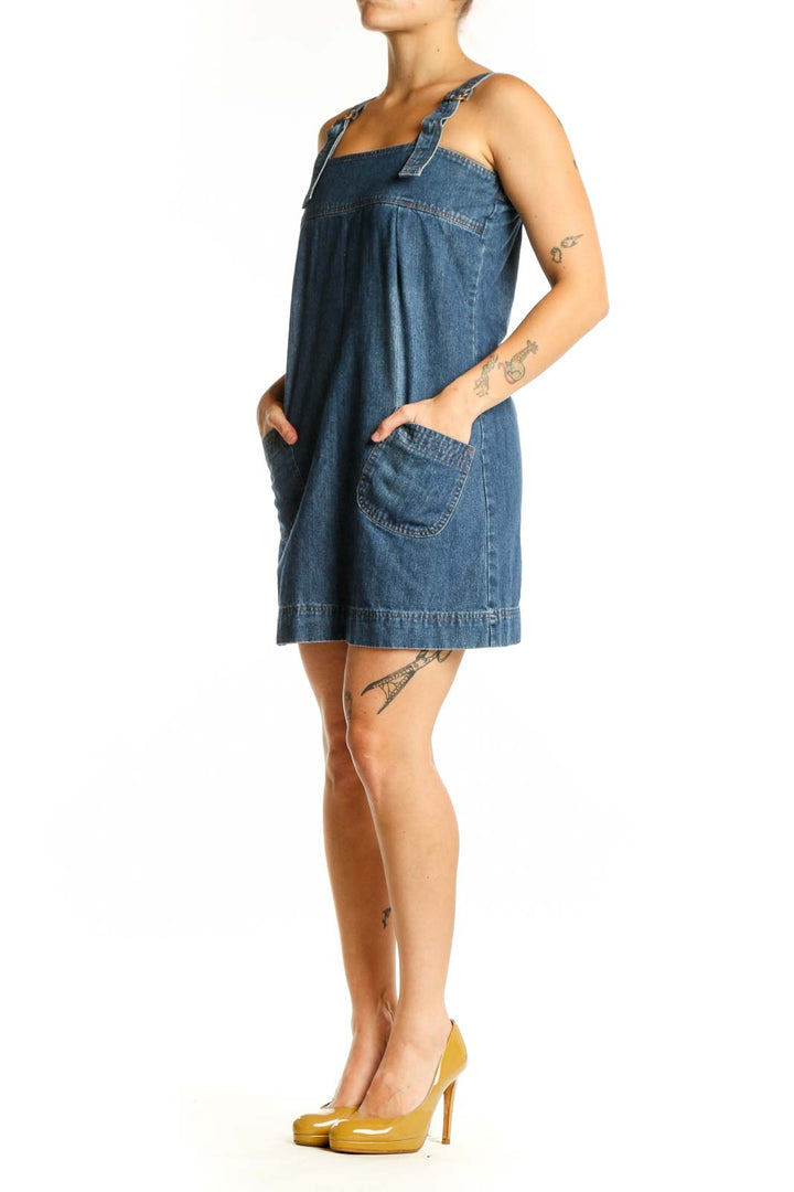 Blue denim sleeveless shift dress with square neckline and patch pockets, front view