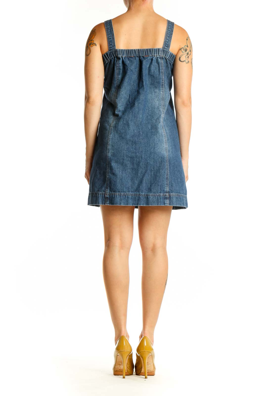 Blue denim sleeveless shift dress with adjustable straps and back patch pocket, back view