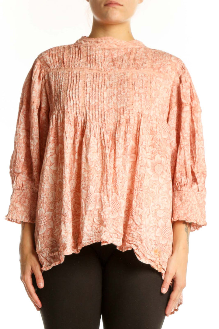 Peach floral cotton blouse with pleated chest and puffed sleeves, front view on model