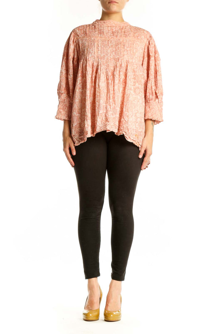 Peach floral cotton blouse with pleated chest and puffed sleeves, front view on model