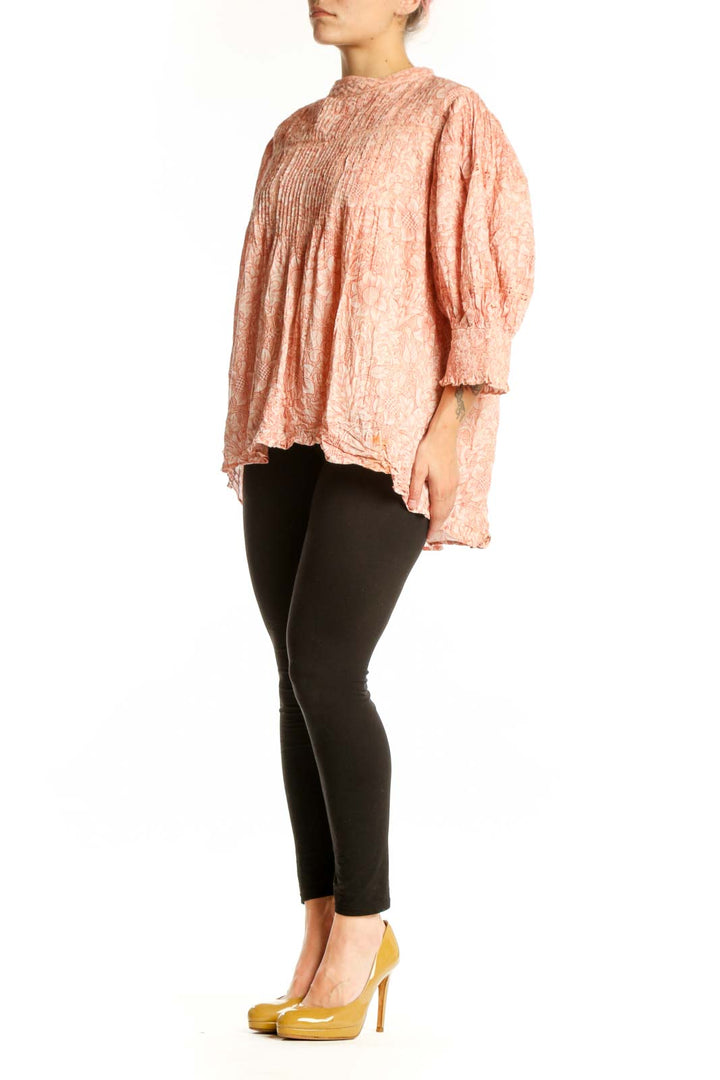 Peach floral cotton blouse with pleated chest and puffed sleeves, front view on model
