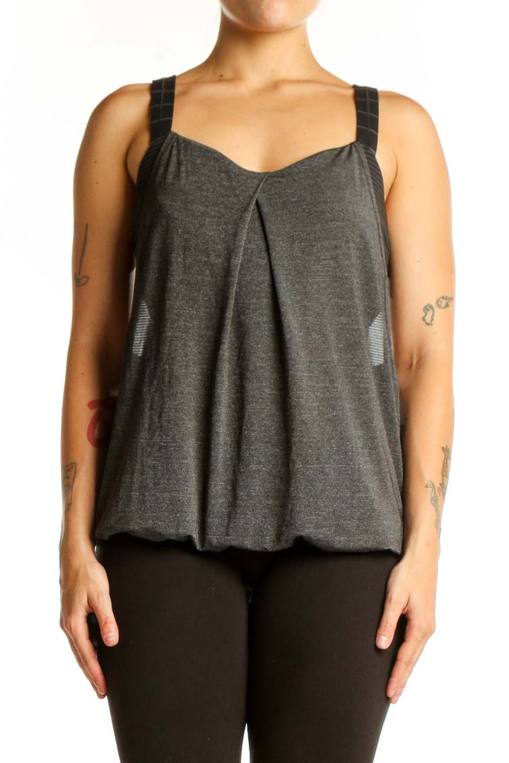Charcoal gray Lululemon activewear tank with pleated front and sweetheart neckline, worn with black leggings