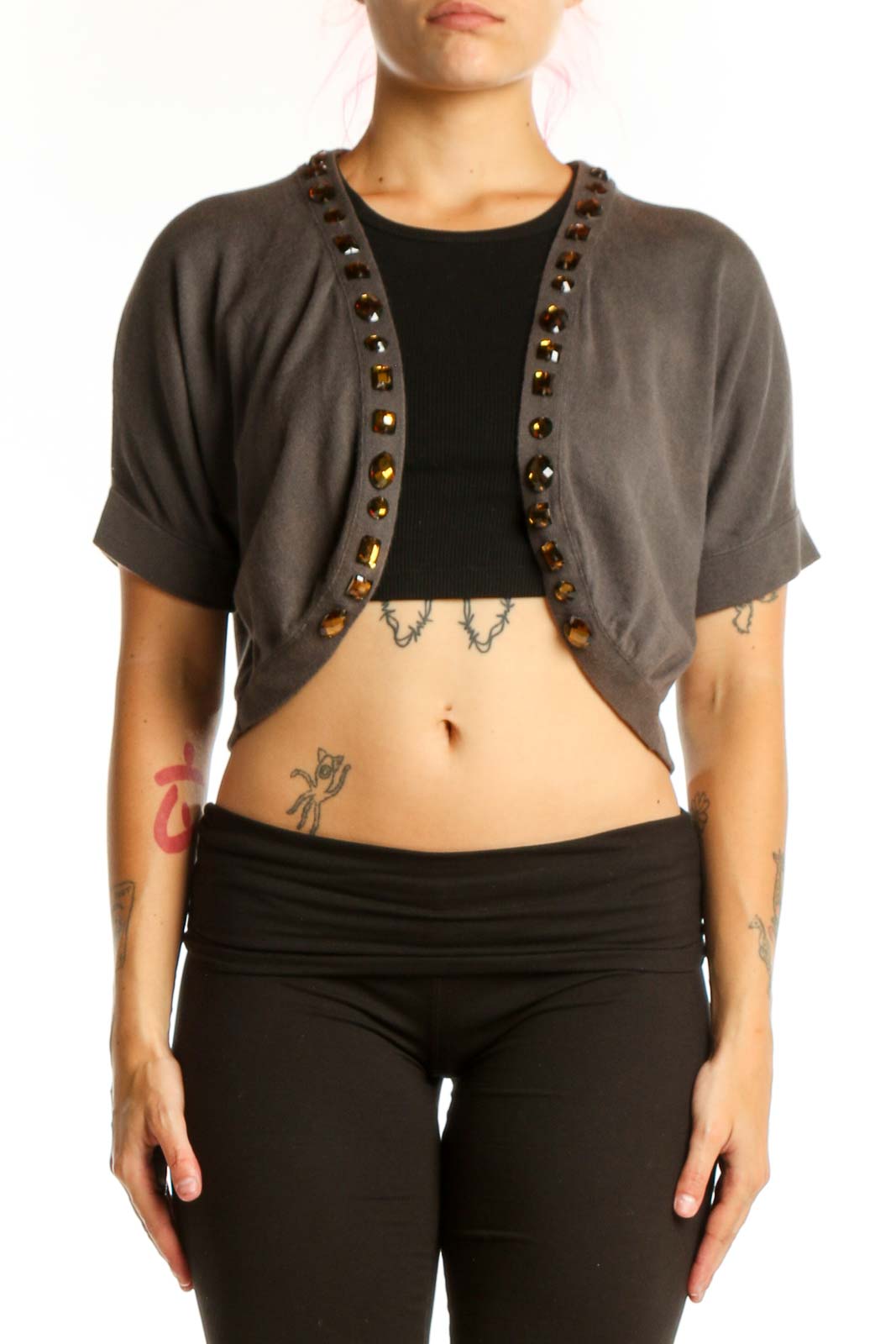 Gray studded cropped cardigan knit with metal stud trim, worn over black top