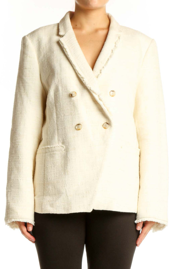 Cream double-breasted blazer with gold buttons and notch lapel collar, front view