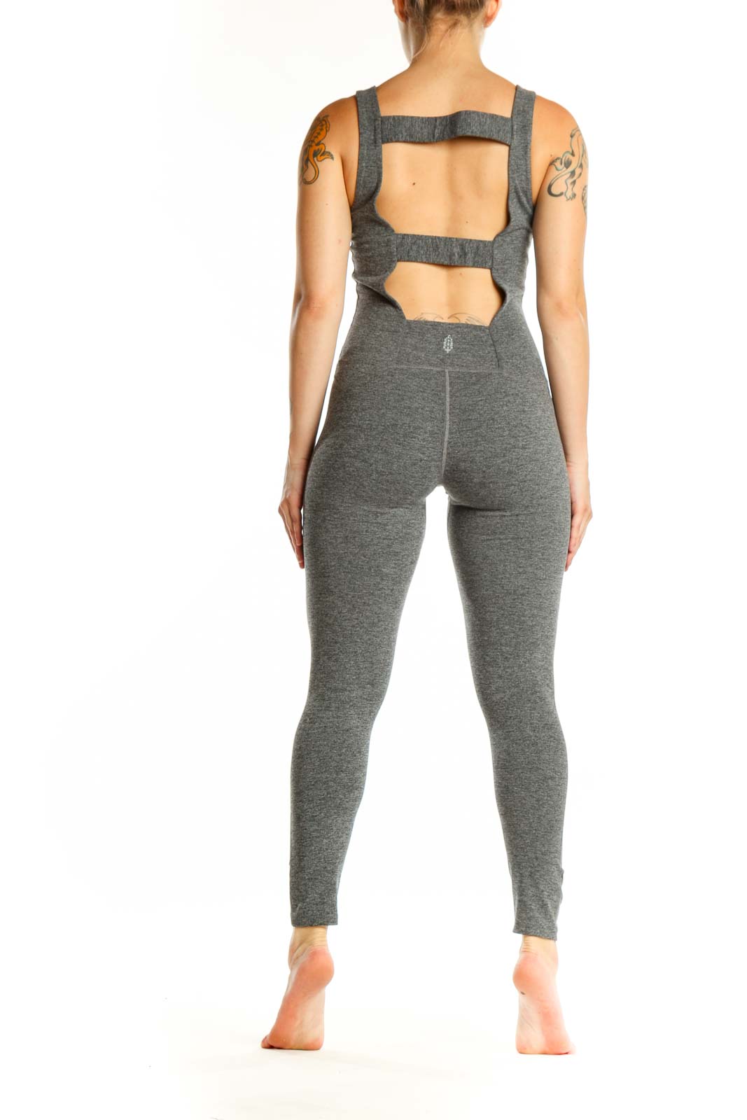 Gray V-neck sleeveless all-in-one jumpsuit back view on model, displaying center seam detail and tapered leg