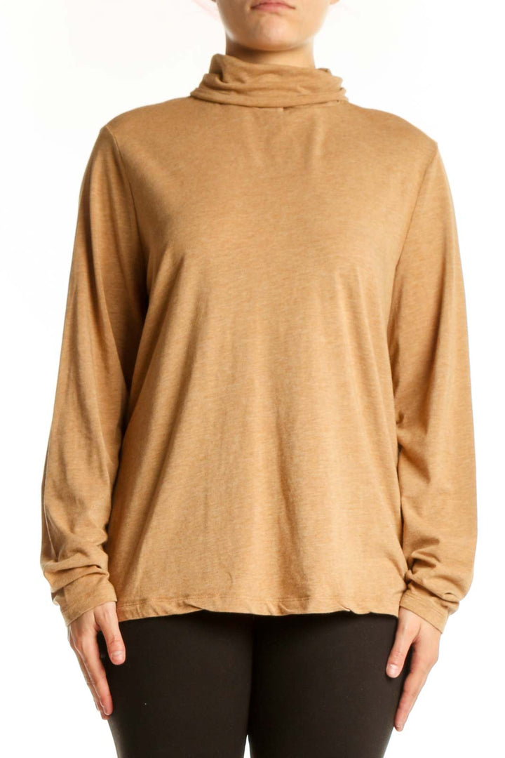 Woman wearing camel turtleneck long sleeve top with relaxed fit, front view