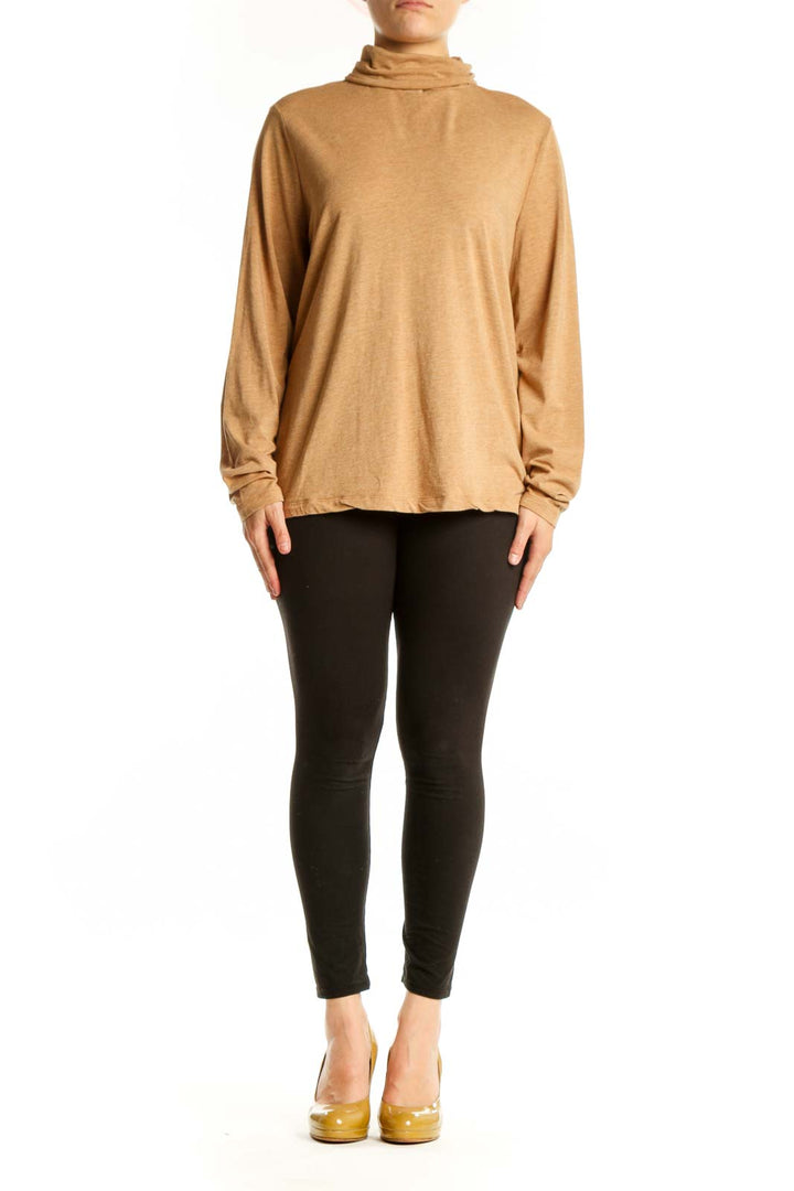 Woman wearing camel turtleneck long sleeve top with relaxed fit, front view