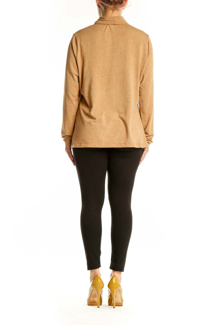 Back view of camel turtleneck long sleeve top showing relaxed silhouette and length