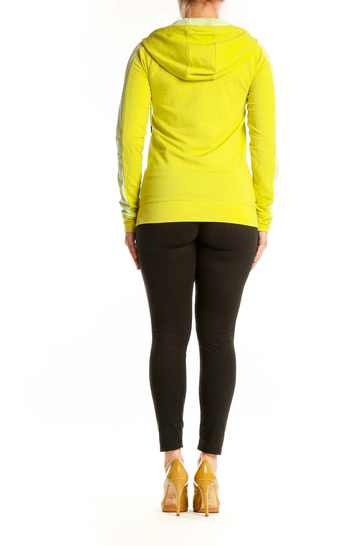 Back view of yellow Under Armour athletic hoodie jacket with adjustable drawstring hood