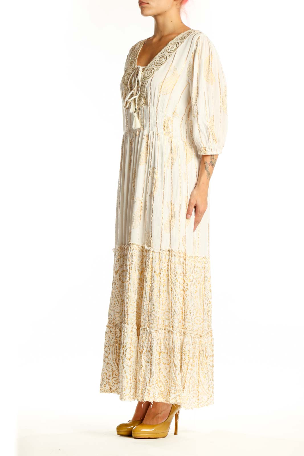Front view of cream viscose maxi dress with embroidered V-neckline, three-quarter sleeves, and tiered lace hem