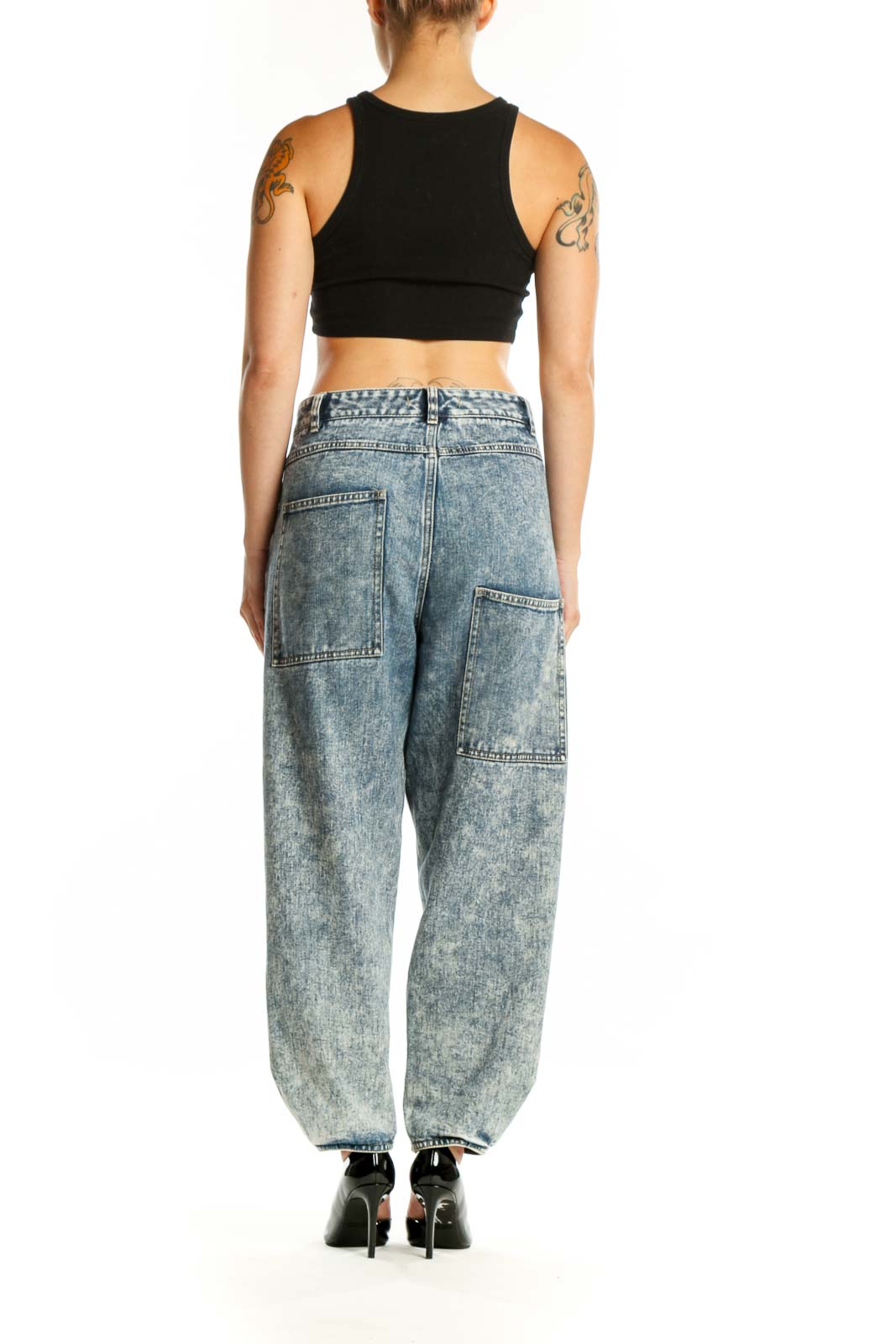 Side view of Tibi acid wash cropped jeans showing the relaxed fit and ankle-length cropped hem