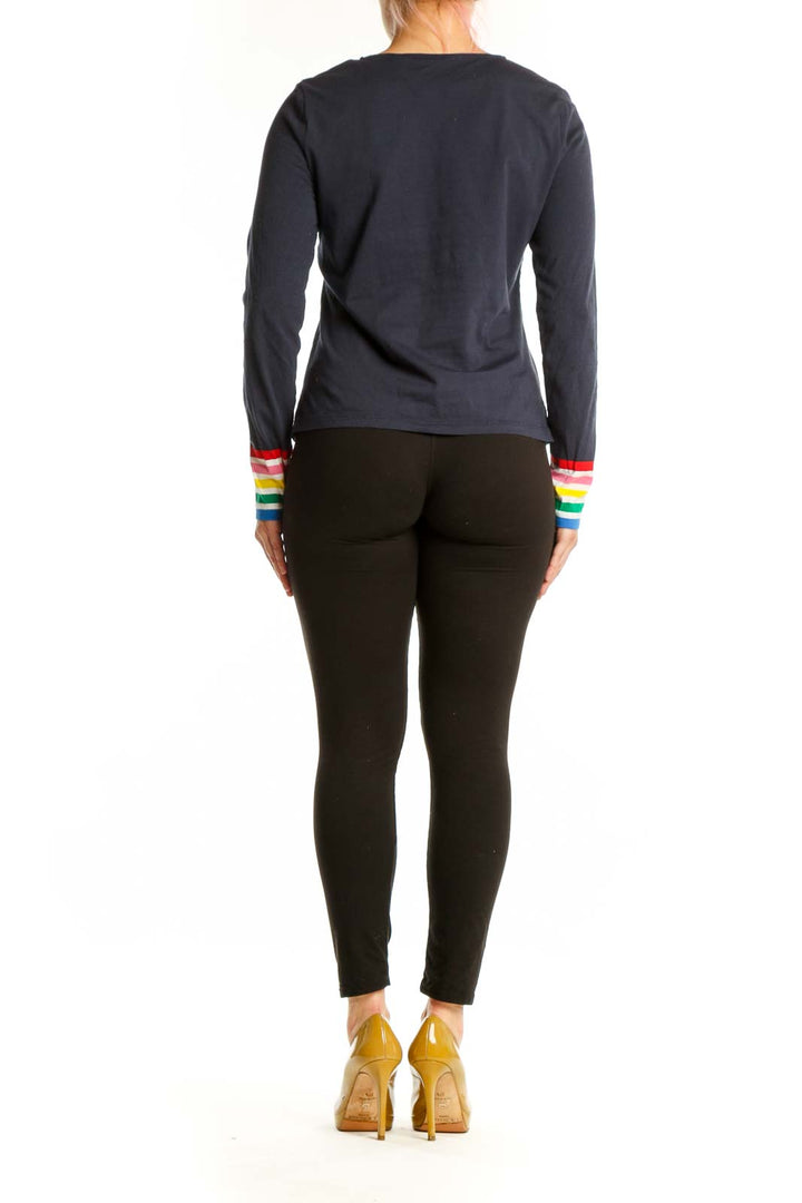 Navy cotton long-sleeve top with rainbow striped cuffs, back view