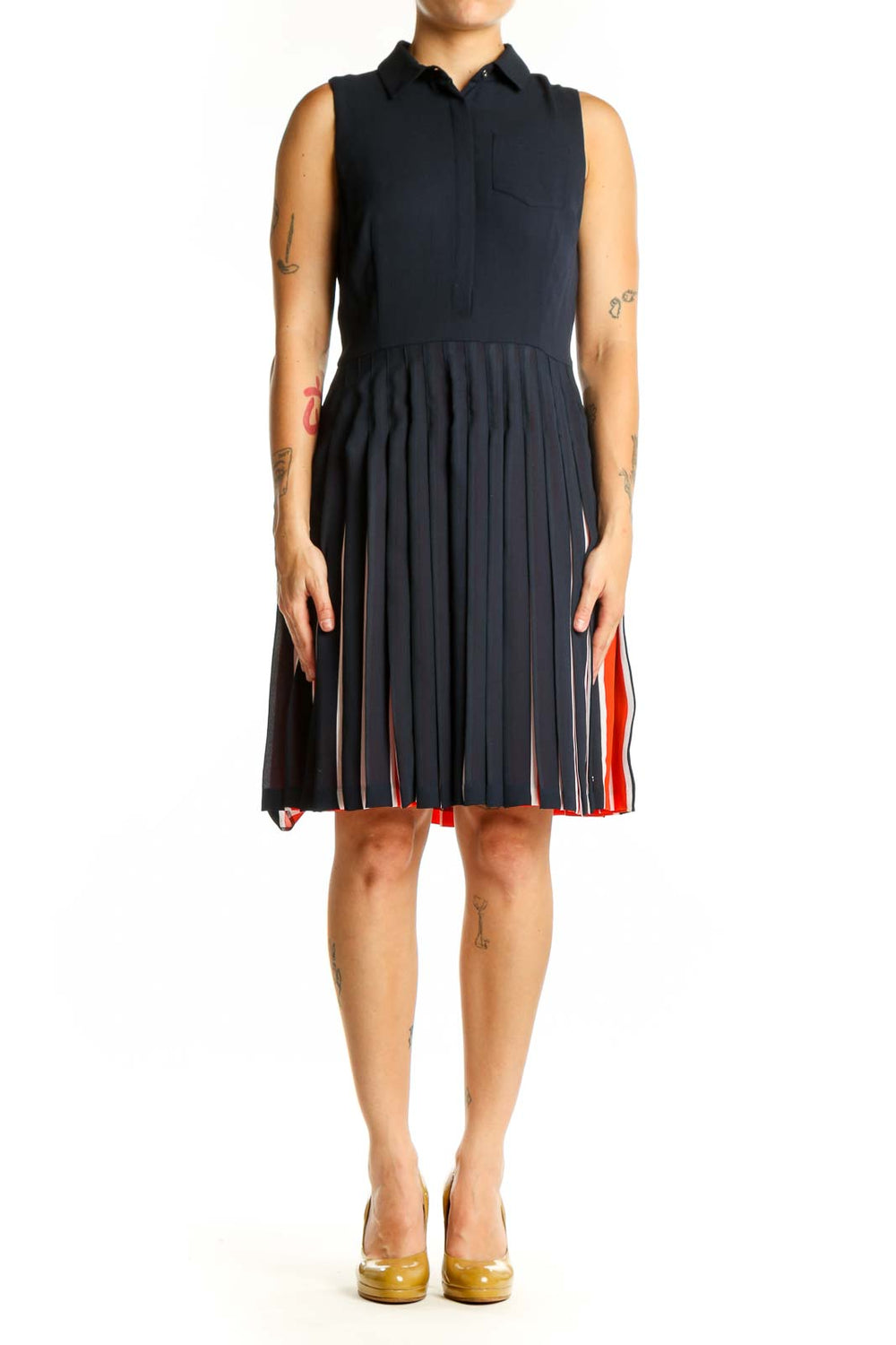 Navy sleeveless pleated shirt dress with red and white striped skirt detail, front view