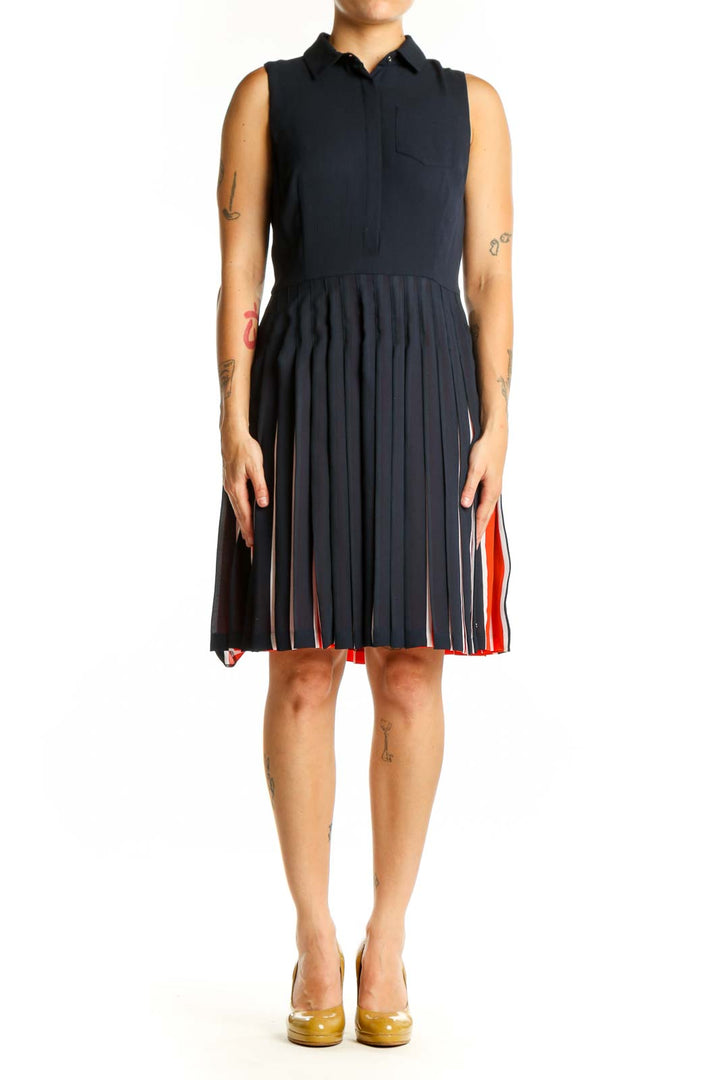 Navy sleeveless pleated shirt dress with red and white striped skirt detail, front view