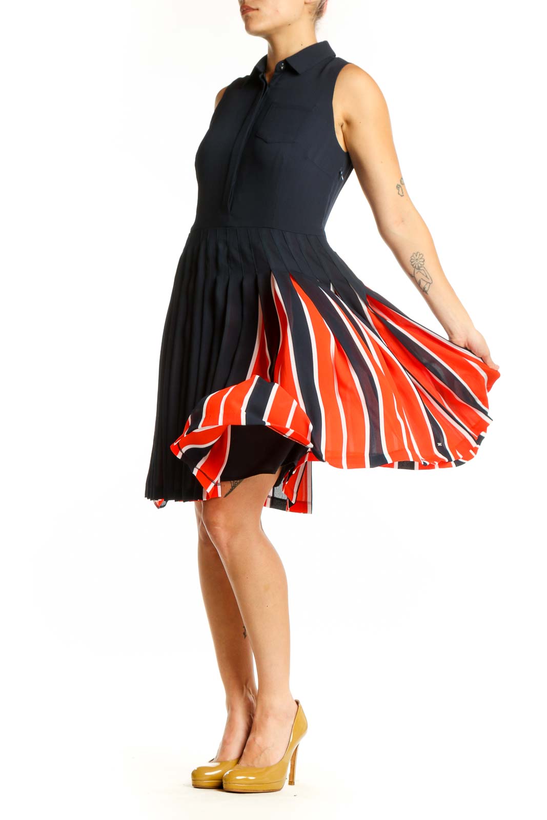 Navy sleeveless pleated shirt dress with red and white striped skirt detail, front view