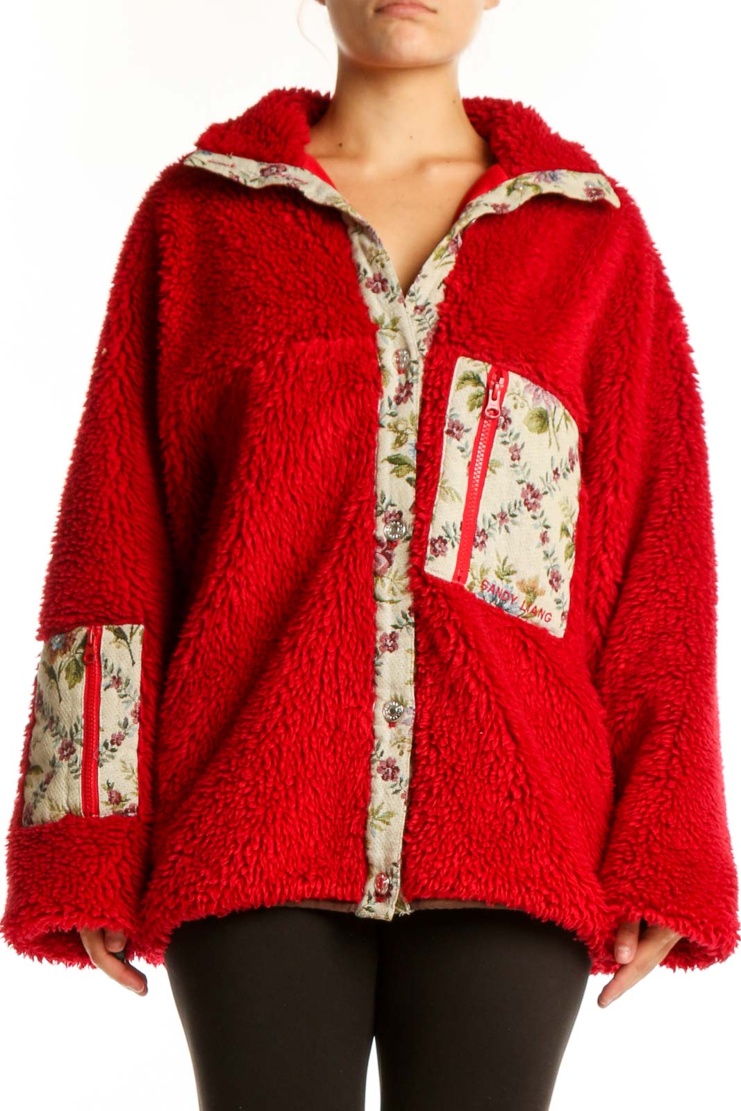 Red fuzzy zip-up jacket with floral-printed trim collar and pockets, worn with black leggings