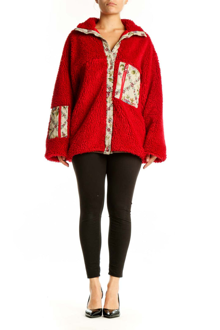 Red fuzzy zip-up jacket with floral-printed trim collar and pockets, worn with black leggings