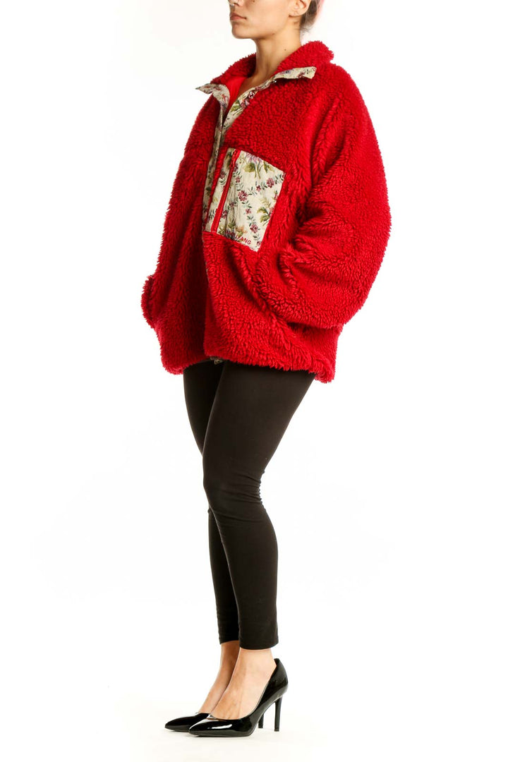 Red fuzzy zip-up jacket with floral-printed trim collar and pockets, worn with black leggings