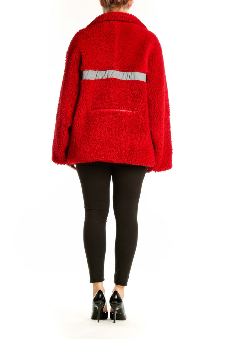 Back view of red fuzzy jacket showing floral-printed trim detail and oversized silhouette