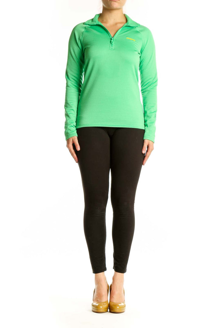 Green Patagonia quarter-zip long sleeve athletic top with yellow logo, front view on model