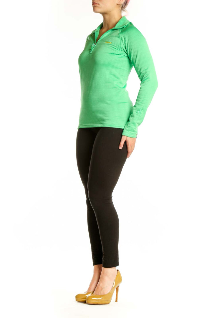 Green Patagonia quarter-zip long sleeve athletic top with yellow logo, front view on model