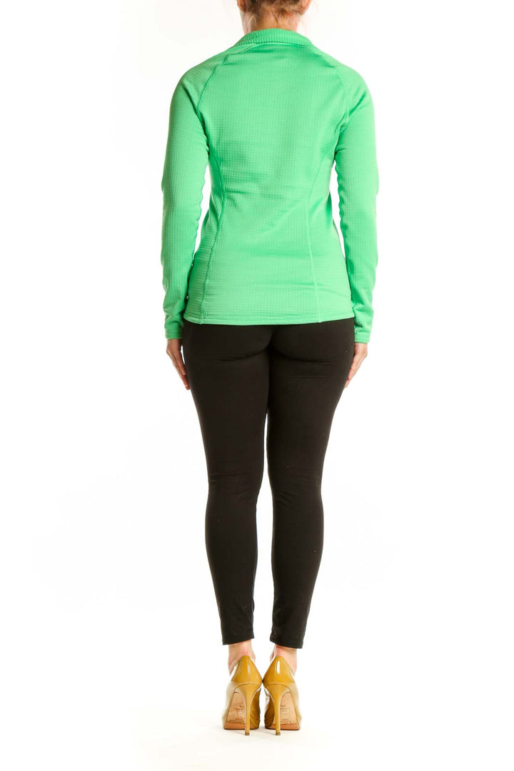 Green Patagonia quarter-zip long sleeve athletic top, back view on model wearing black leggings