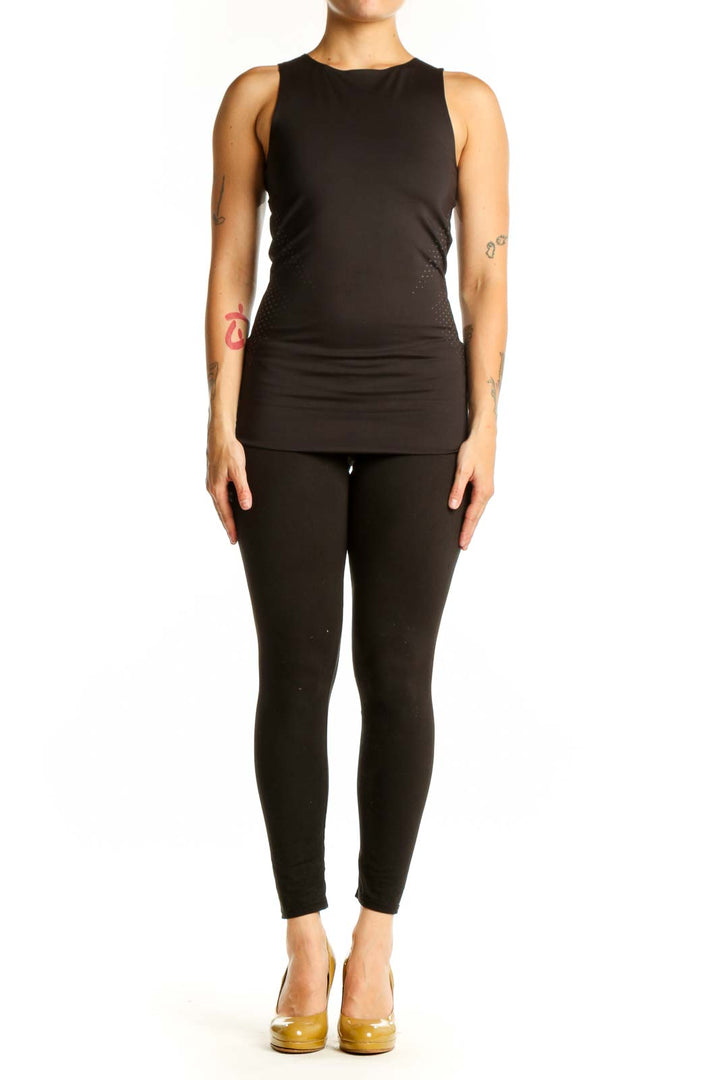 Black Puma athletic tank top front view with mesh side detailing, fitted silhouette on model