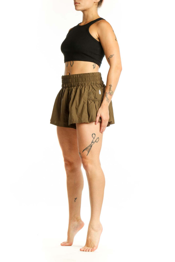 Olive green flared activewear shorts with elasticated waistband and side pockets, front view