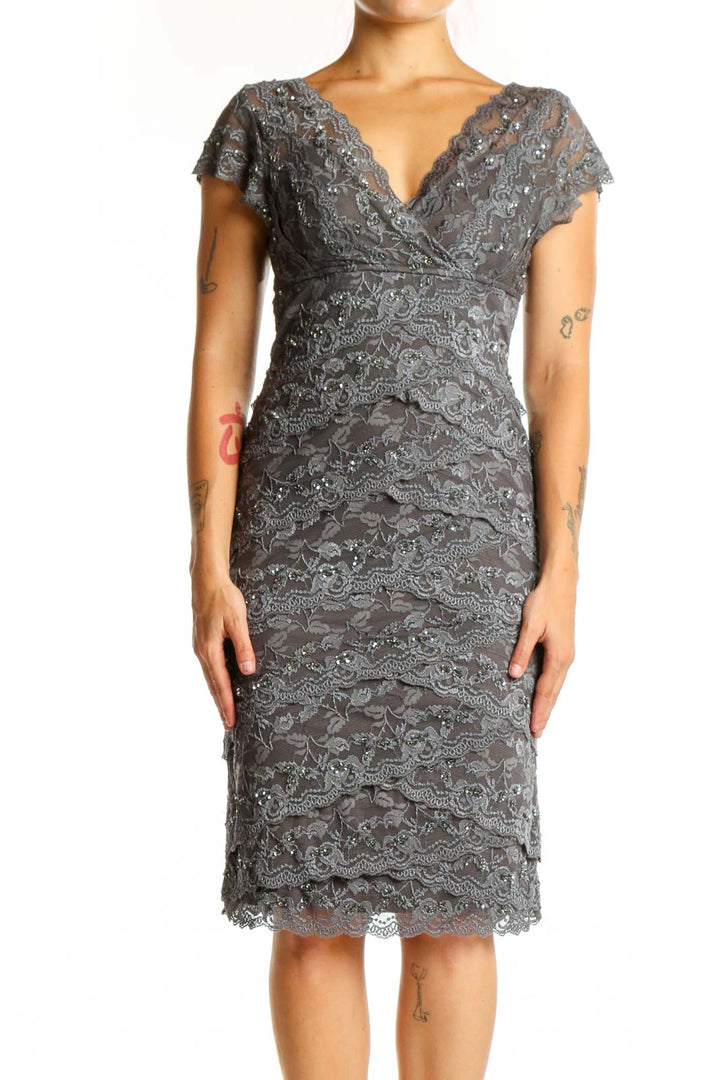 Gray lace wrap cocktail dress with flutter sleeves and ruched detailing, front view