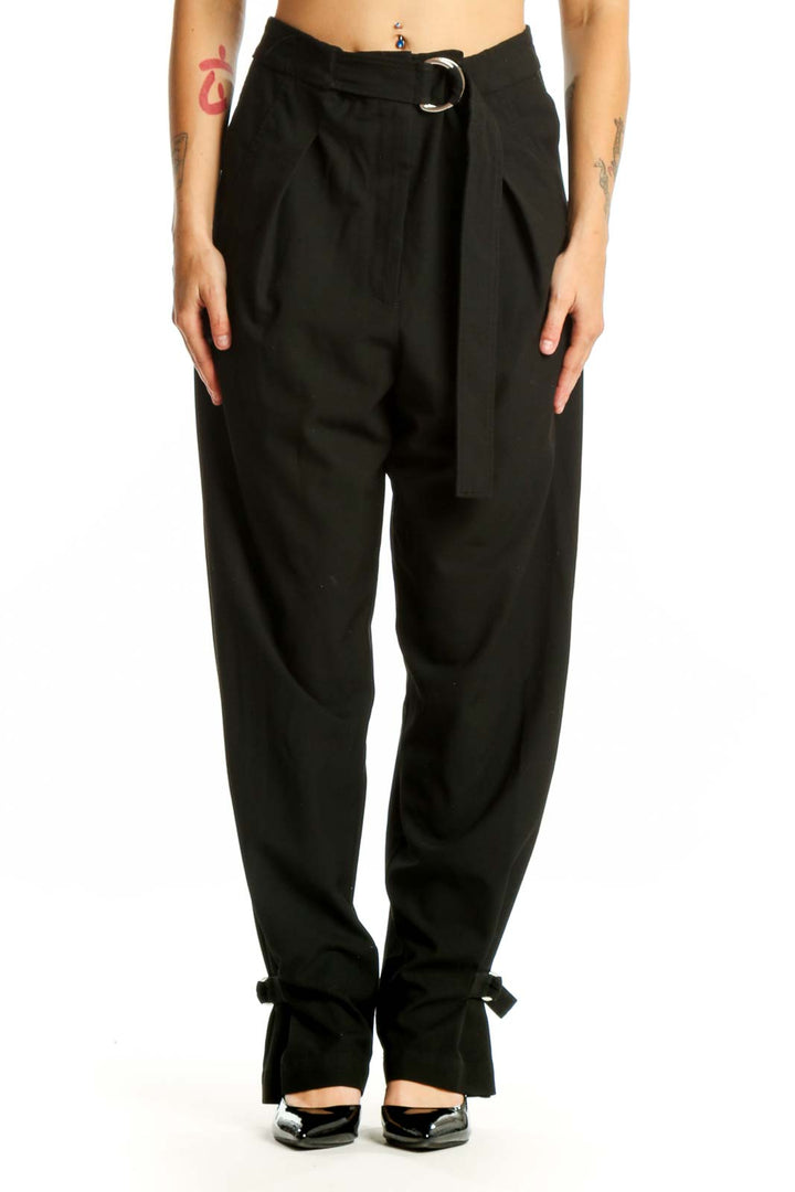 Black paperbag waist pants with tie belt and ankle bow detail, front view