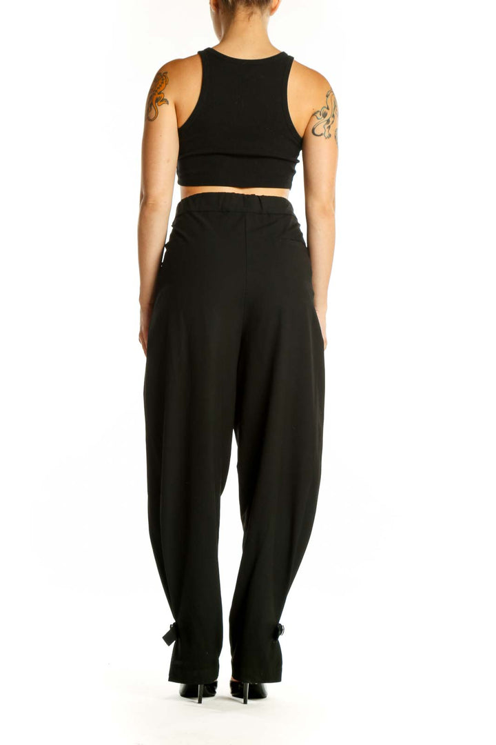 Black paperbag waist pants with tie belt detail, back view showing relaxed fit