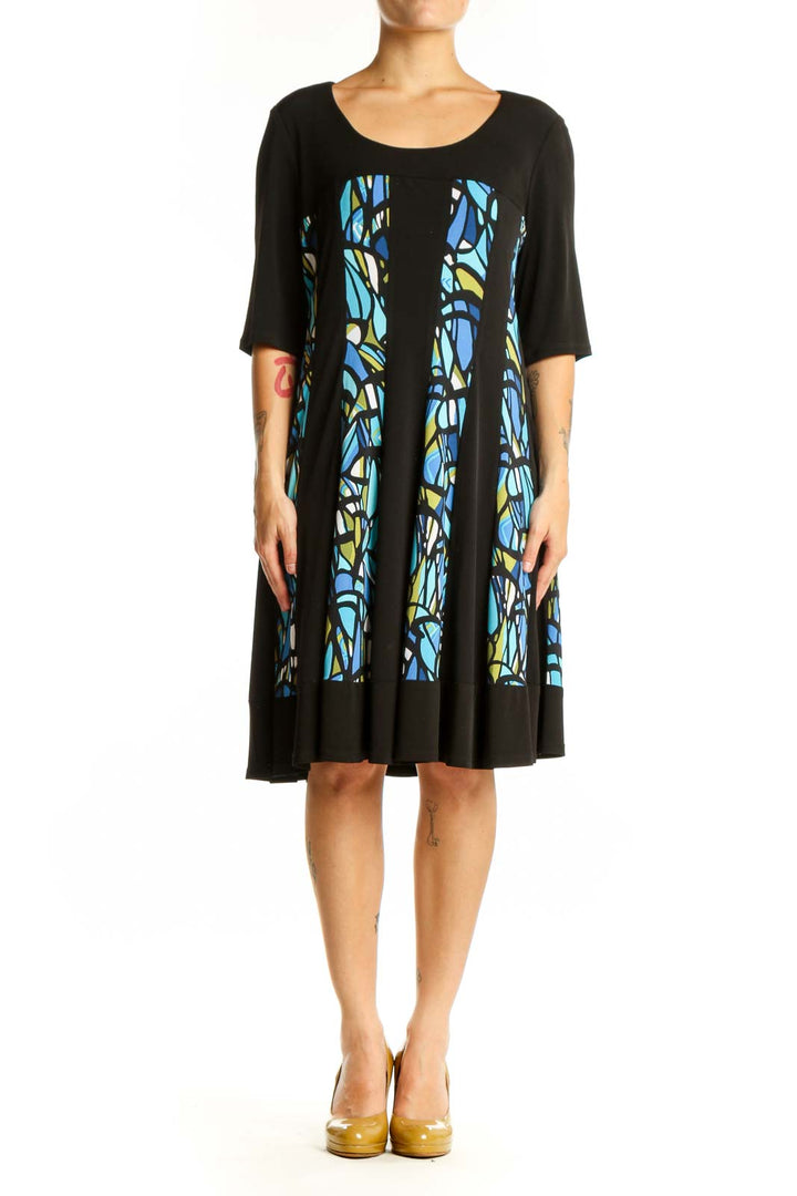 Black A-line dress with blue and yellow stained glass pattern panels, three-quarter sleeves, front view