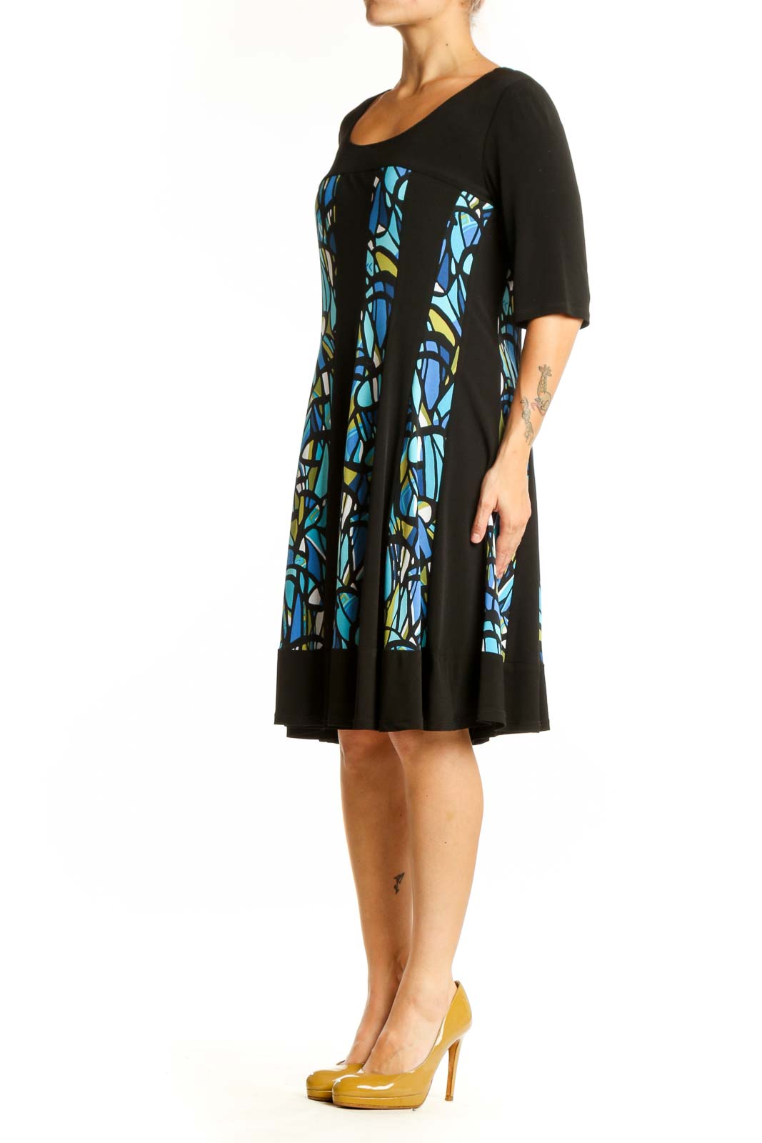 Black A-line dress with blue and yellow stained glass pattern panels, three-quarter sleeves, front view