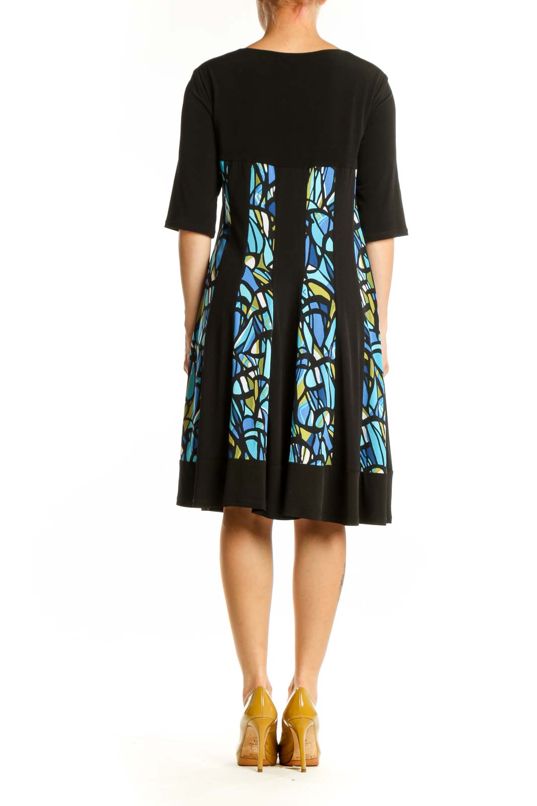 Black A-line dress with blue and yellow stained glass pattern panels, three-quarter sleeves, back view